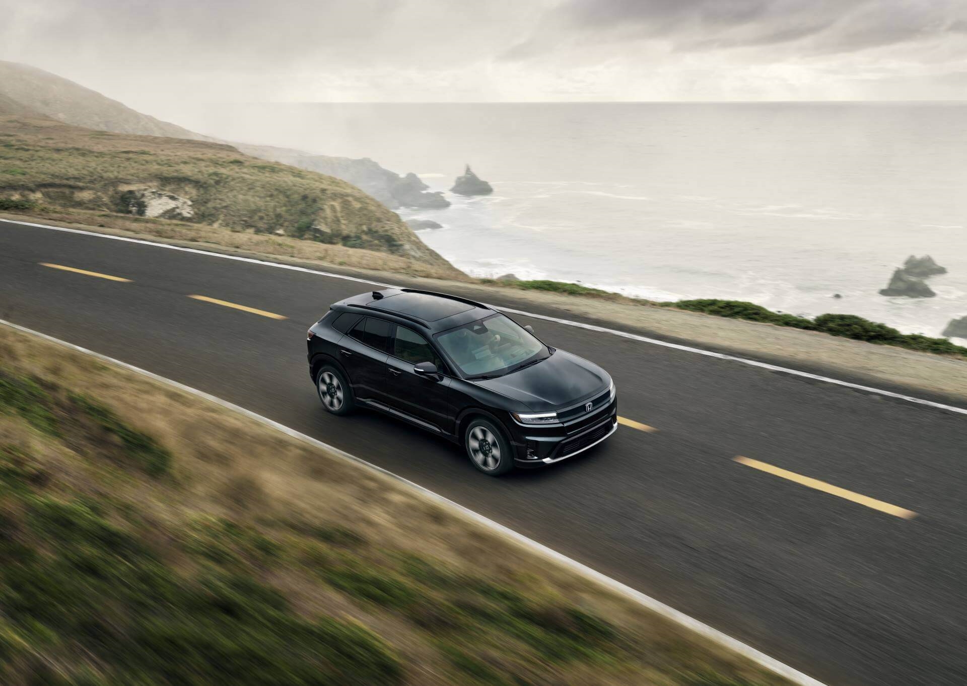 Honda Prologue cornering at high speed on California coast with great acceleration due to a powerful battery