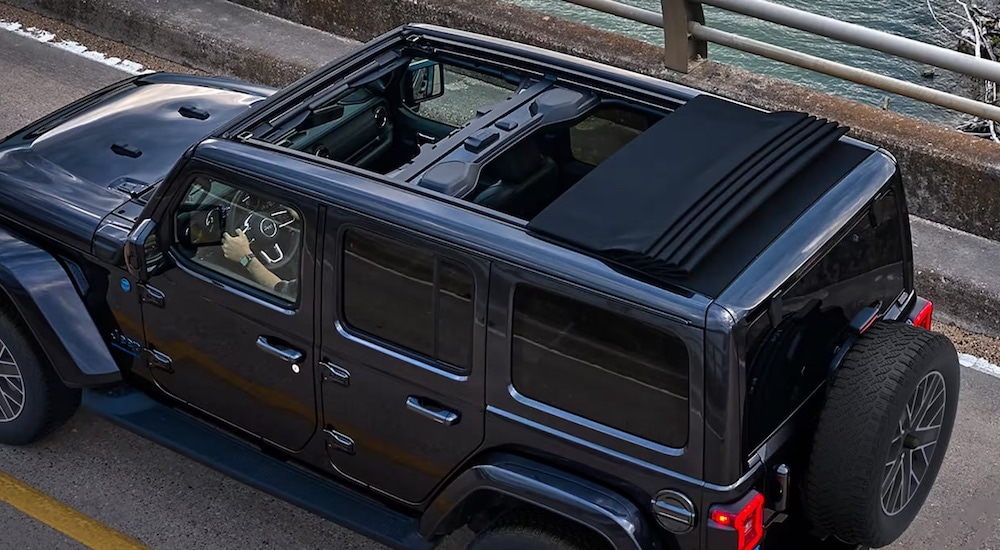 A grey 2024 Jeep Wrangler is shown from the rear at a high angle.