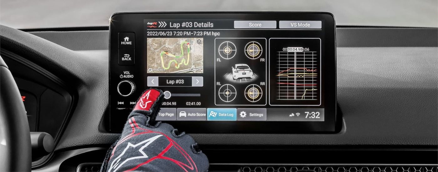 A close up shows the infotainment screen with lap times in a 2024 Honda Civic Type R.