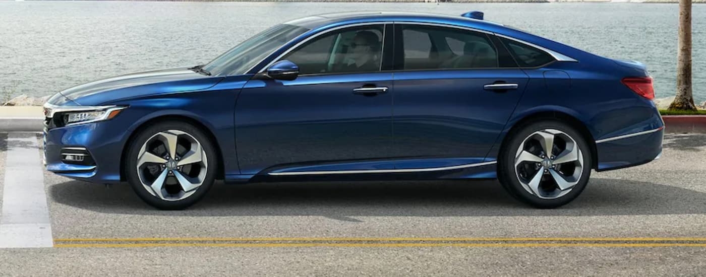 A blue 2020 Honda Accord Touring is shown parked at an intersection after leaving a Seattle used Honda dealer.