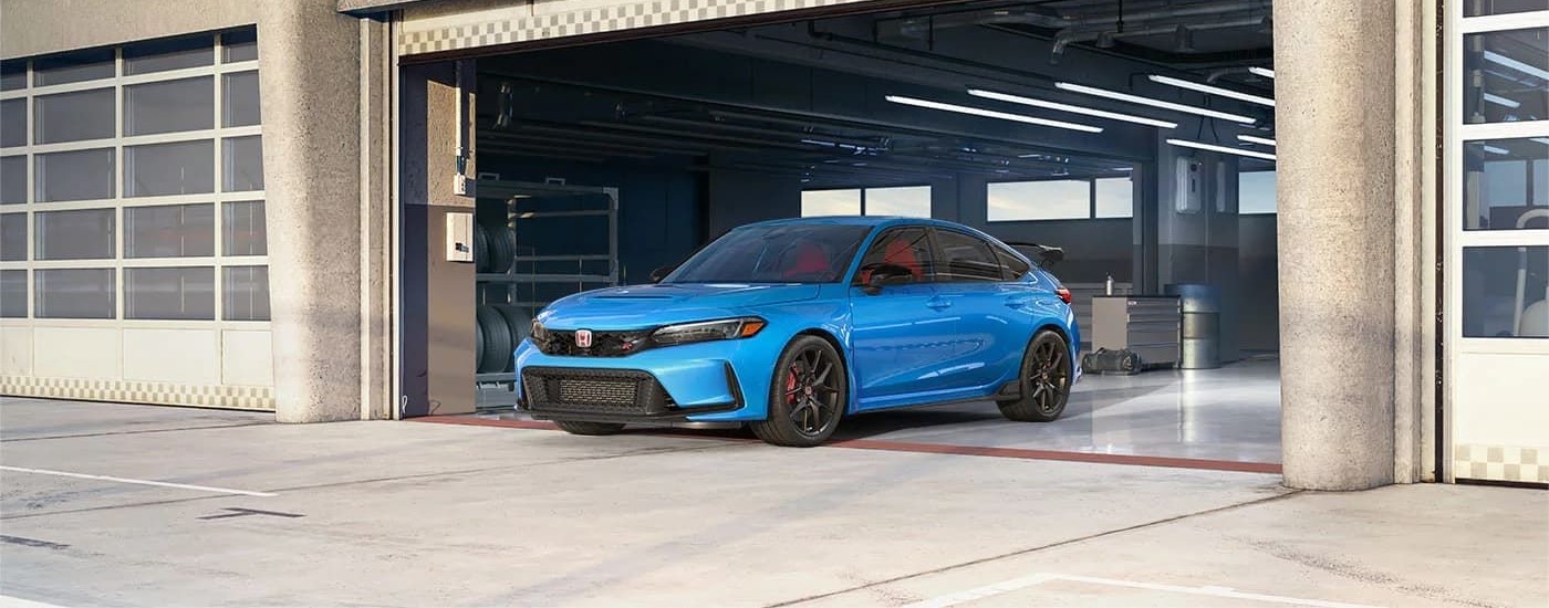 A blue 2023 Honda Civic Type-R is shown parked in a garage near a Honda dealer near Maltby.