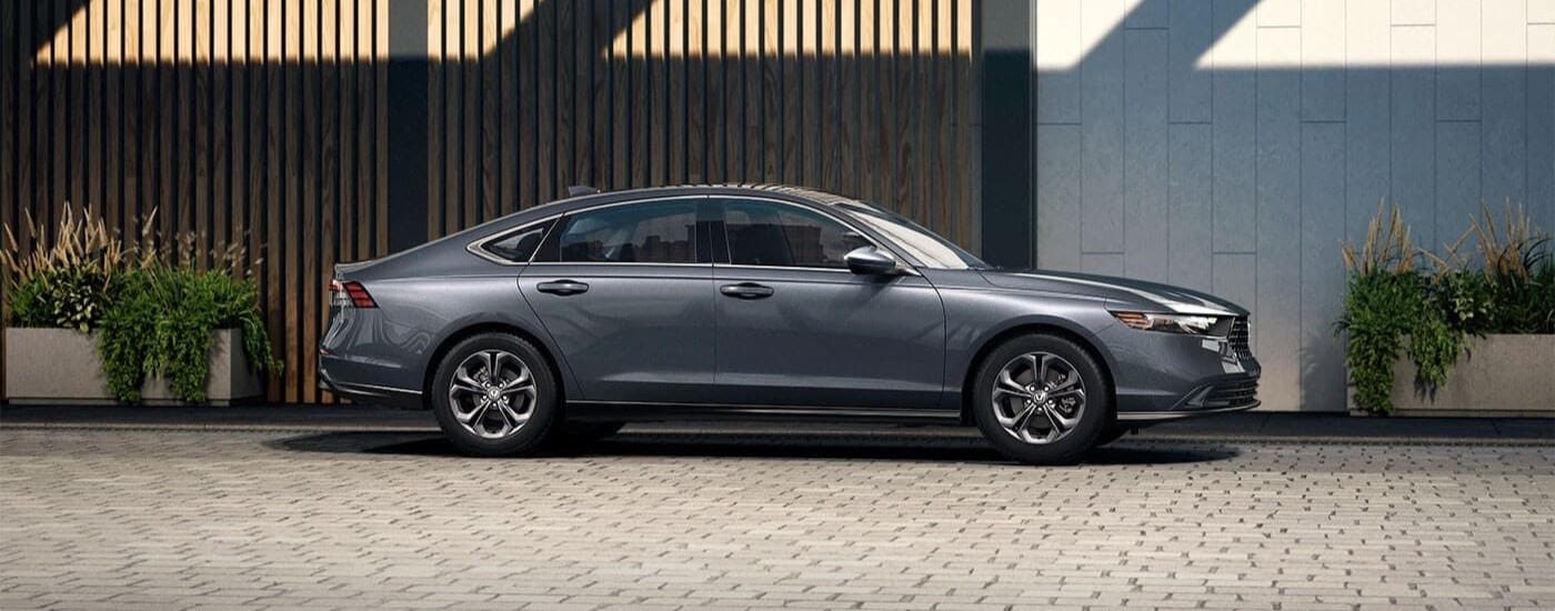 A gray 2024 Honda Accord is shown parked on a driveway.