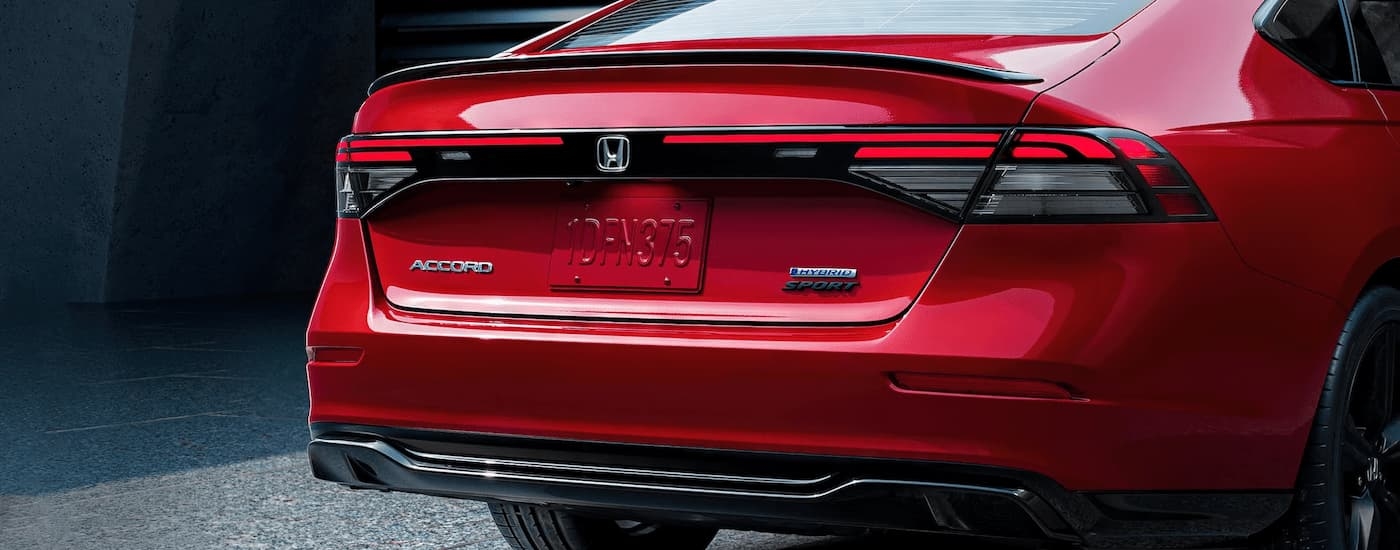 A red 2023 Honda Accord Hybrid for sale in Everett, WA is shown parked in a garage.