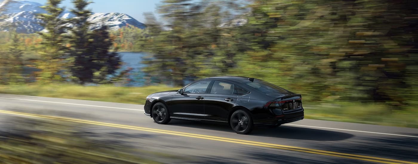 A black 2023 Honda Accord is shown from the rear at an angle after leaving a Lake Stevens Honda dealer.
