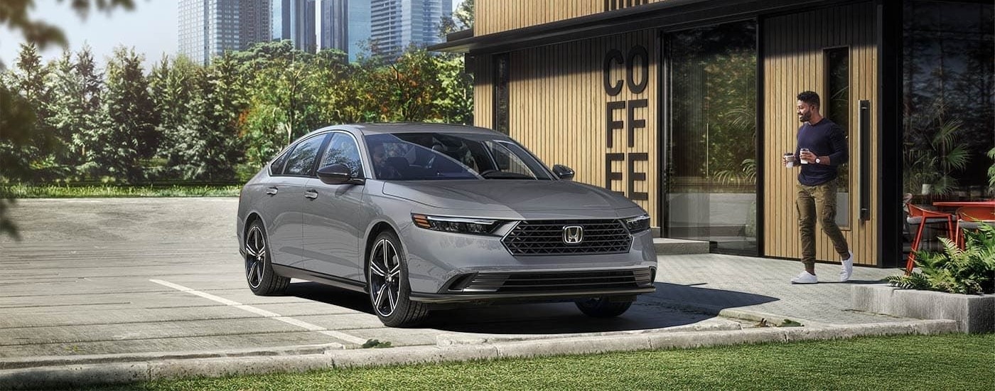 A grey 2023 Honda Accord is shown from the front at an angle after leaving a Kirkland Honda dealer.