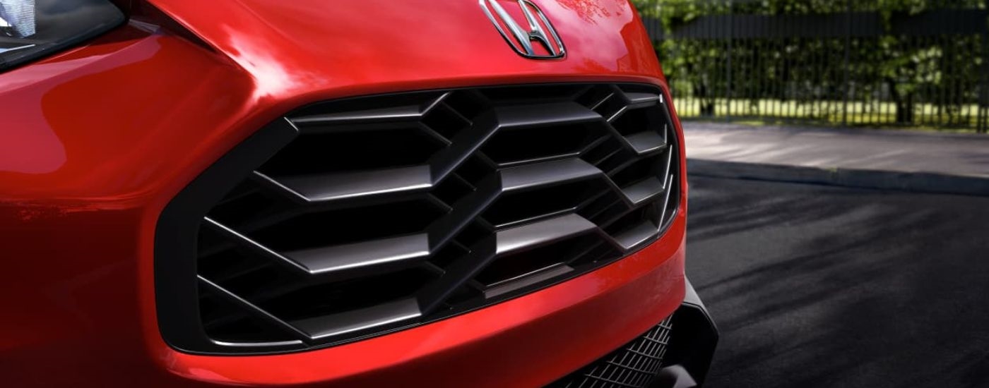 A close up shows the grille on a red 2023 Honda HR-V.