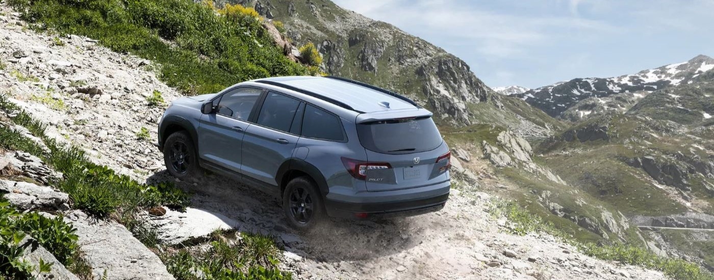 A grey 2022 Honda Pilot Trailsport is shown from the rear at an angle after leaving a Honda dealer near Lynnwood, WA.