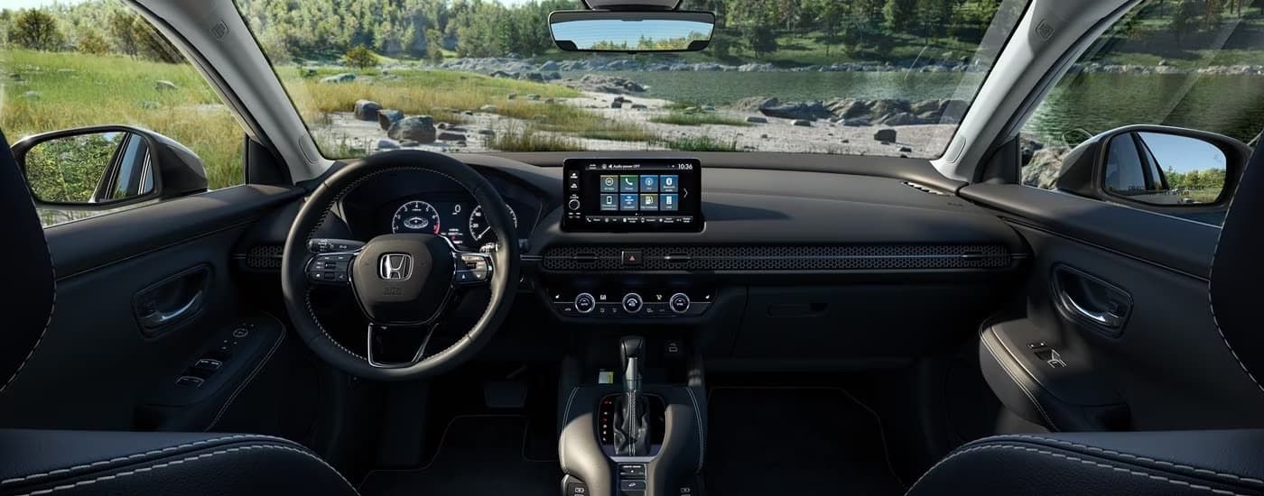 The black interior and dash of a 2023 Honda HR-V EX-L is shown.