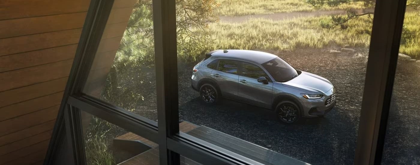 A gray 2024 Honda HR-V for sale near Marysville is shown through a window.