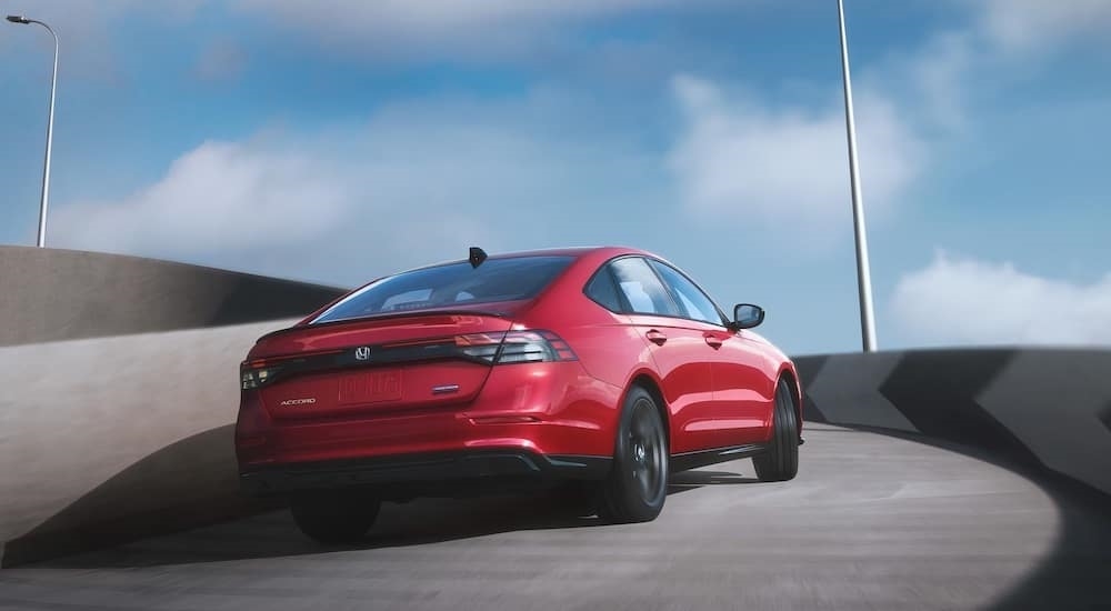 A red 2024 Honda Accord is shown driving.