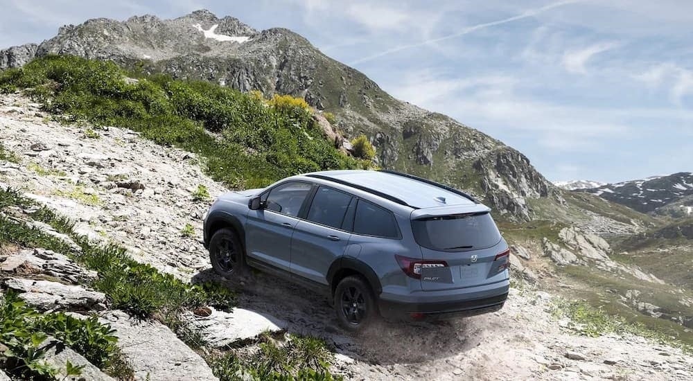 A grey 2022 Honda Pilot Trailsport is shown from the rear at an angle.