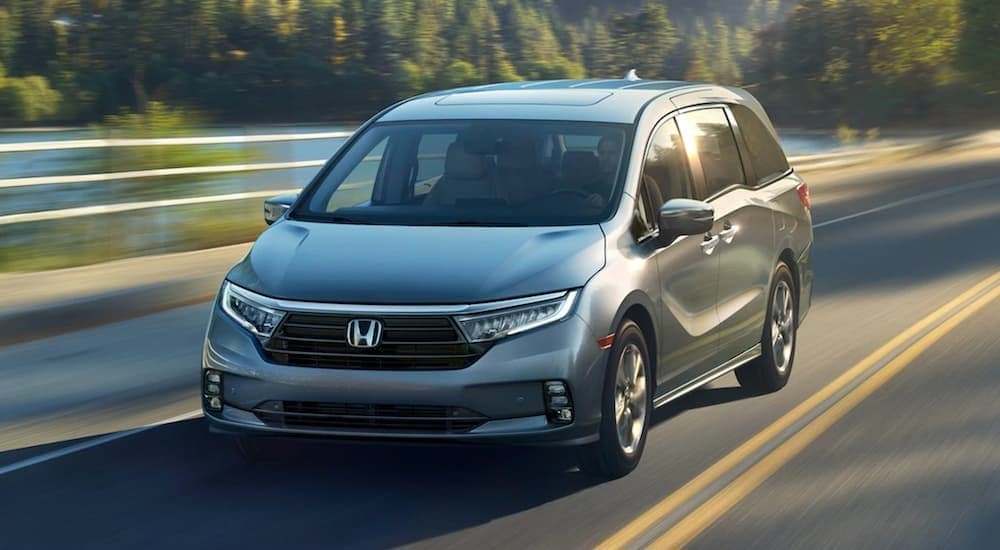 A grey 2020 Honda Odyssey Elite is shown from the front at an angle after leaving a used Honda dealer.