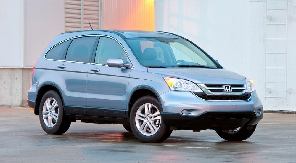 A blue 2011 Honda CR-V is shown from the front at an angle after leaving a dealer that has a used Honda CR-V for sale.