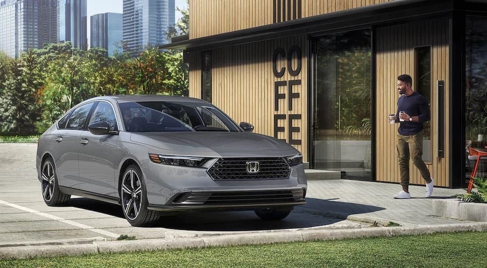 A grey 2023 Honda Accord is shown from the front at an angle.