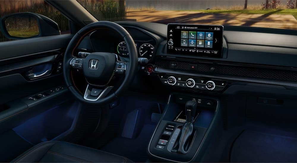 A close up shows the dash and infotainment screen in a 2023 Honda CR-V Hybrid Sport Touring.