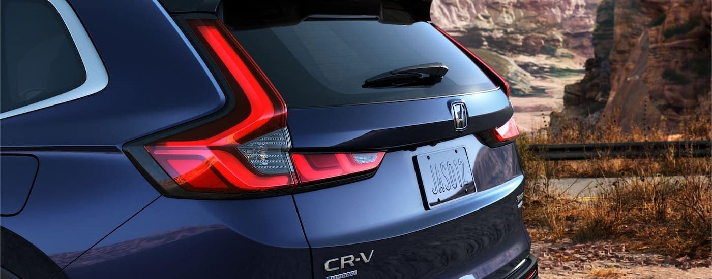 A close up of the rear of a blue 2023 Honda CR-V Sport Touring Hybrid is shown.