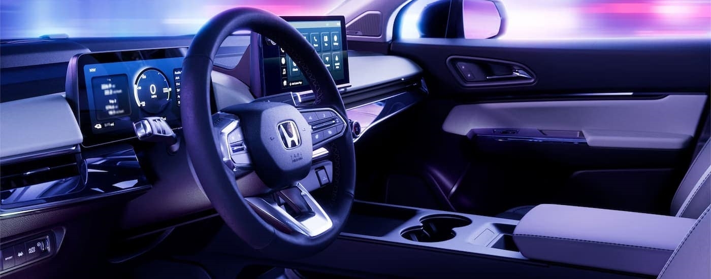 The interior of a 2024 Honda Prologue shows the steering wheel and center console.