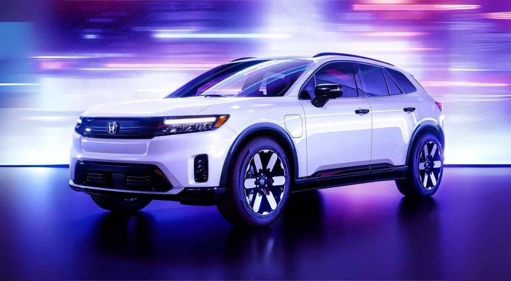 A white 2024 Honda Prologue is parked near a Kenmore Honda dealer.