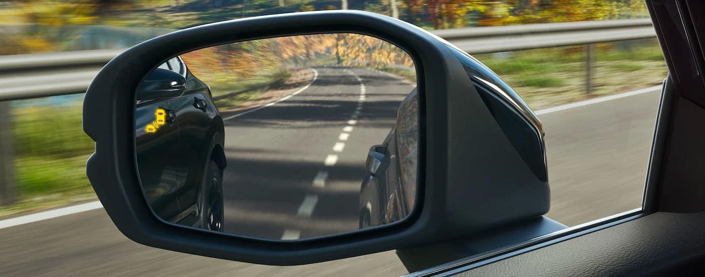 The blind spot monitoring icon is shown on the mirror on a 2023 Honda CR-V.