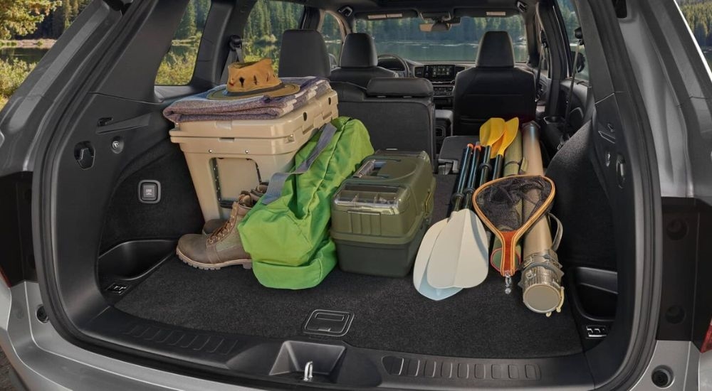 Gear is shown in the trunk of a silver 2024 Honda Passport.