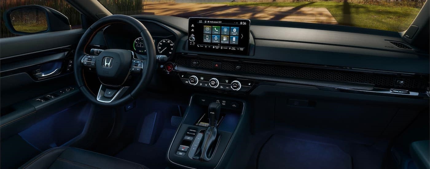 A close up shows the dash and infotainment screen in a 2023 Honda CR-V Hybrid Sport Touring.