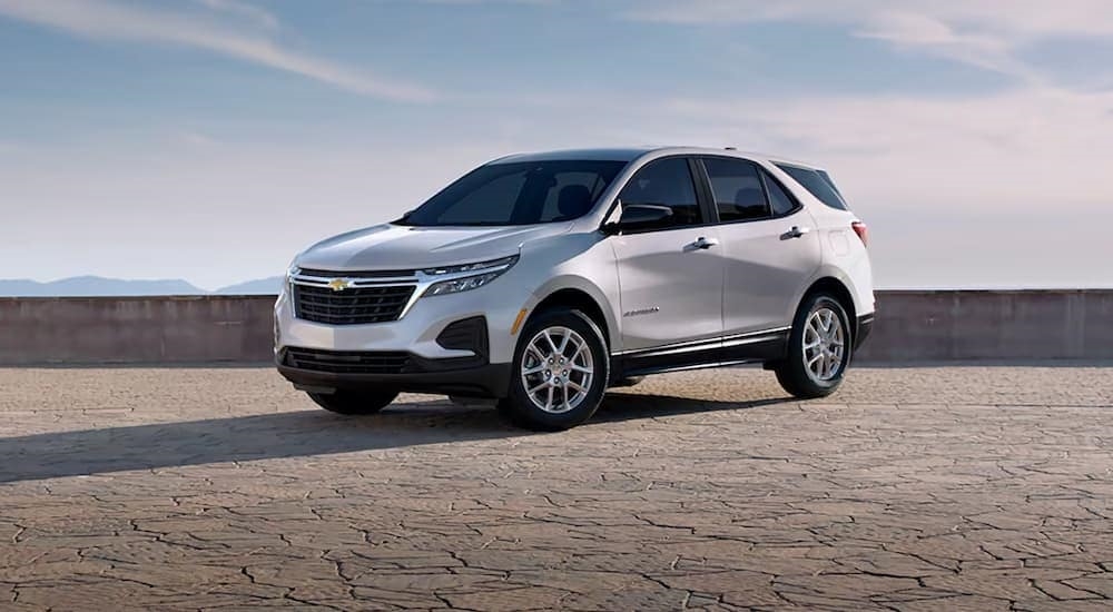 A 2024 Chevy Equinox LS parked under an open sky.
