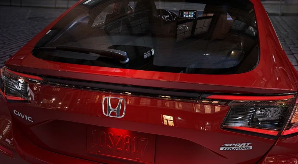 A close up shows the rear end of a red 2024 Honda Civic Sport Touring.