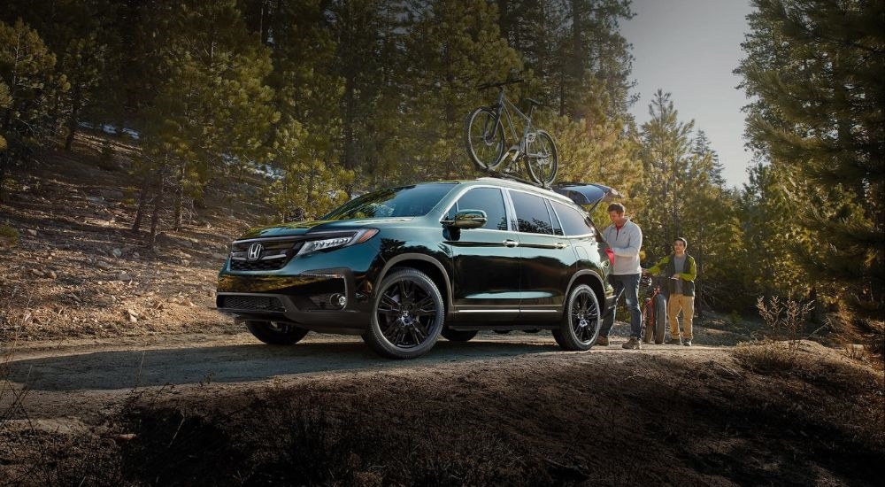 A black  2020 Honda Pilot Elite is shown after shopping for used SUVs for sale.