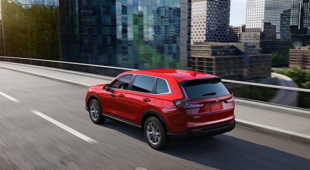 Overhead view of a red 2024 Honda CR-V driving on a bridge.