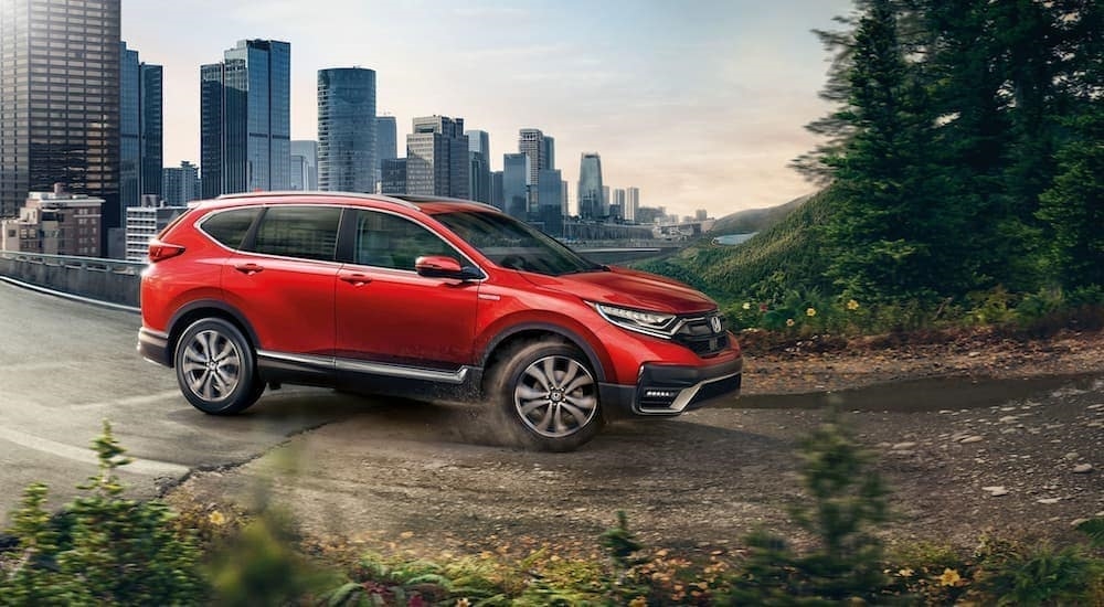 A red 2020 Honda CR-V is shown driving.