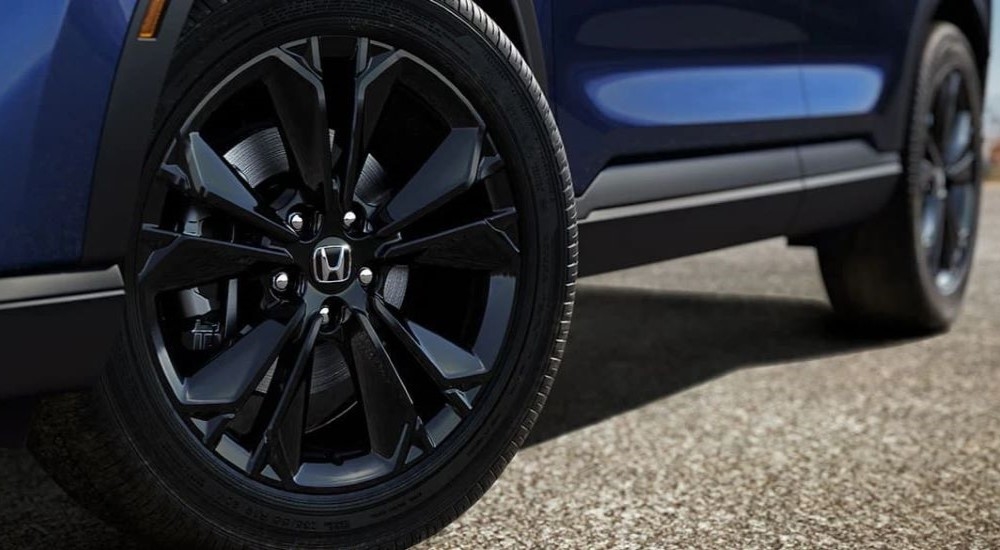 A close up shows a black rim on 2023 Honda CR-V Hybrid Sport Touring.