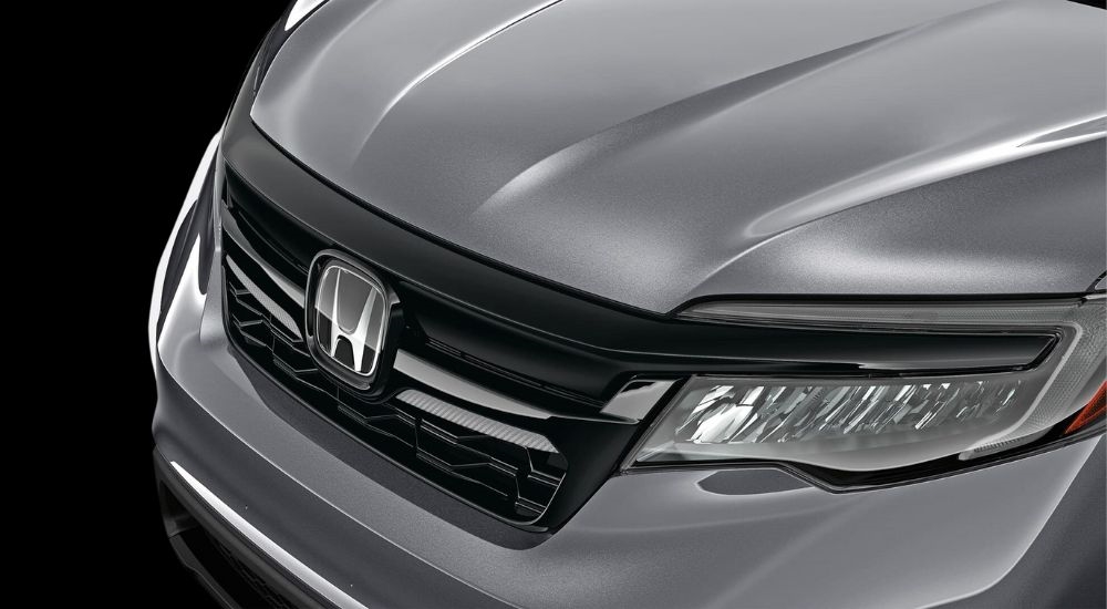 A close up shows grille on a grey 2020 used Honda Pilot for sale.