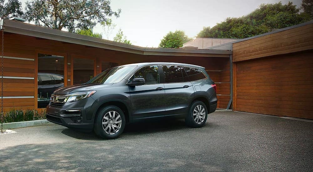 A blue 2020 Honda Pilot LX is shown parked on a driveway.