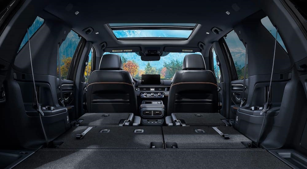 The interior of a 2023 Honda Pilot Trailsport is shown through the trunk.