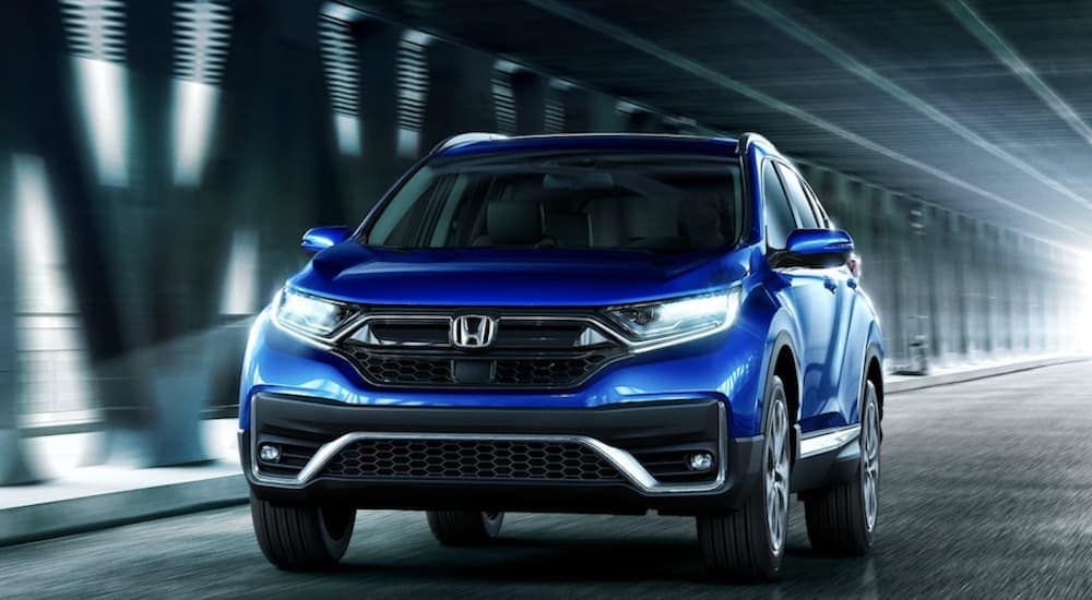 A blue 2022 Honda CR-V is shown driving through a tunnel.