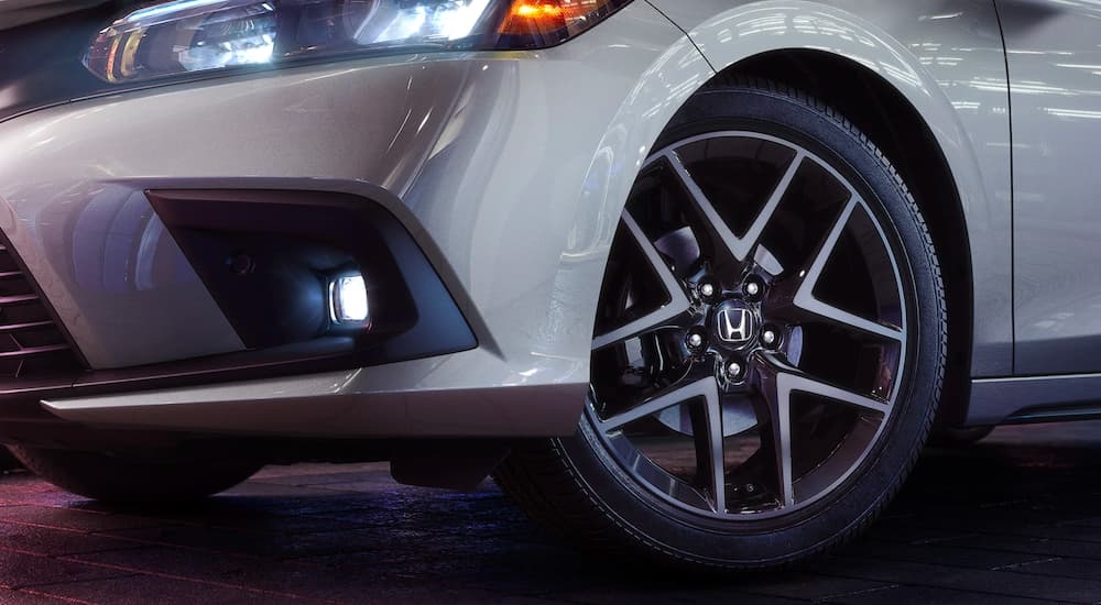 A close up shows the front driver side rim on a silver 2023 Honda Civic Sport Touring.
