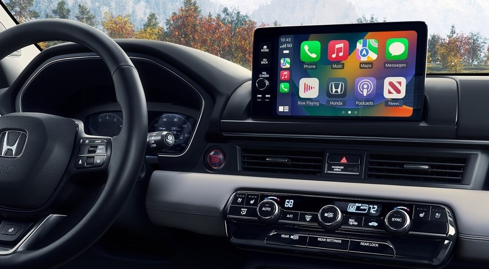 The steering wheel and infotainment screen in a 2024 Honda Pilot Elite.