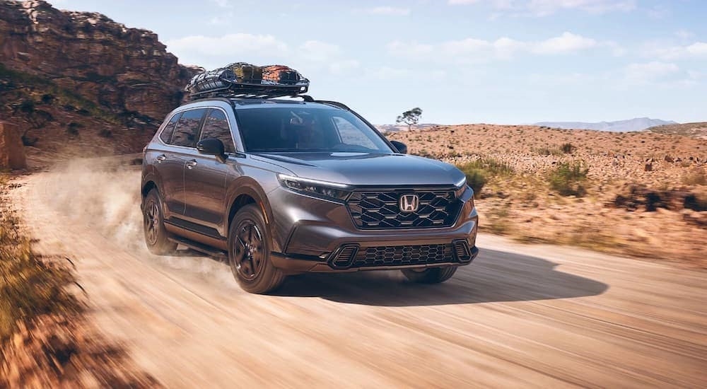 A grey 2023 Honda CR-V is shown from the front at an angle after leaving a dealer that has a Honda CR-V for sale near Seattle.