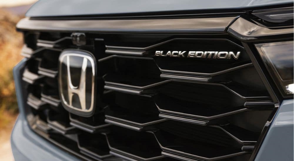 A clsoe-up of the Black Edition badge on the front grille of a 2025 Honda Pilot Black Edition.