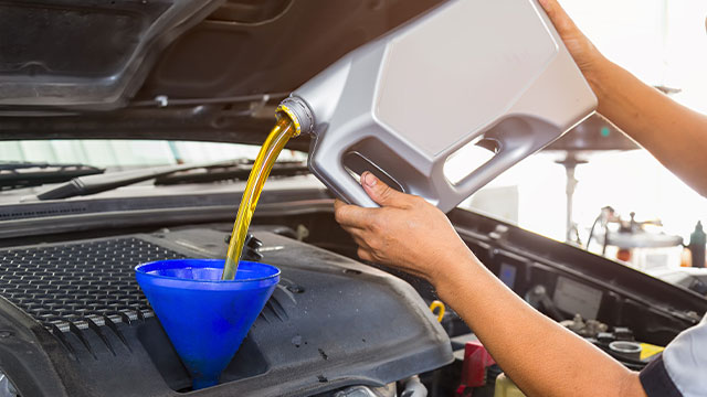 Vehicle Technician Performing Oil Change 