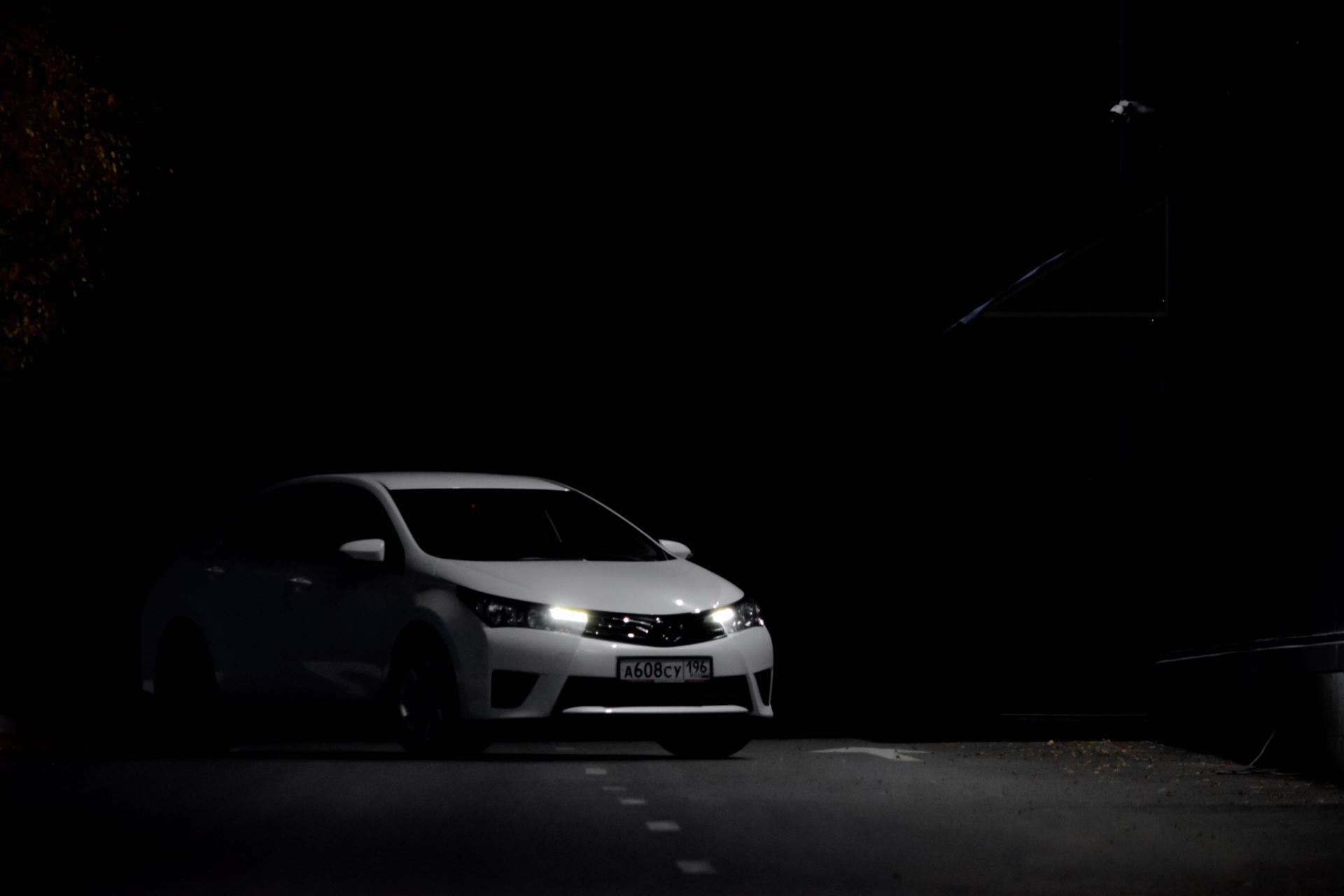 used Toyota Corolla with headlamps at night.