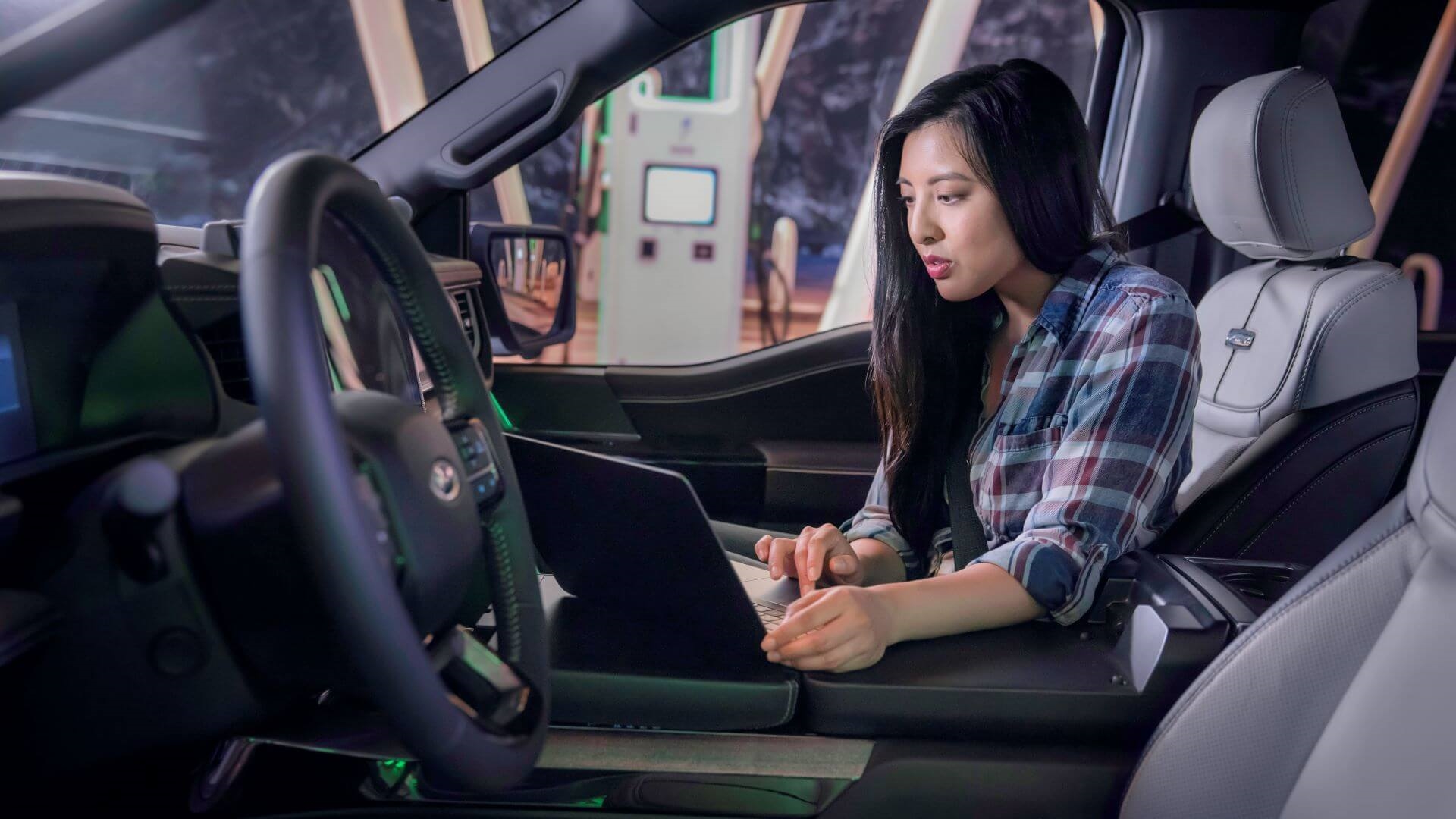 Woman searching for EV charging stations in Ford's network.