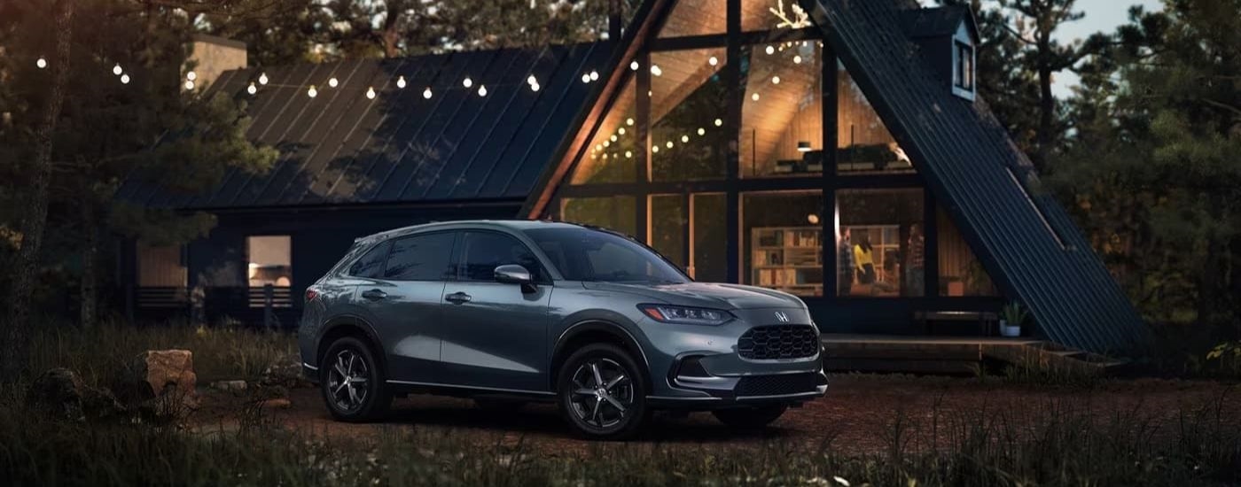 A grey Honda HR-V EX-L is shown parked near a cabin.