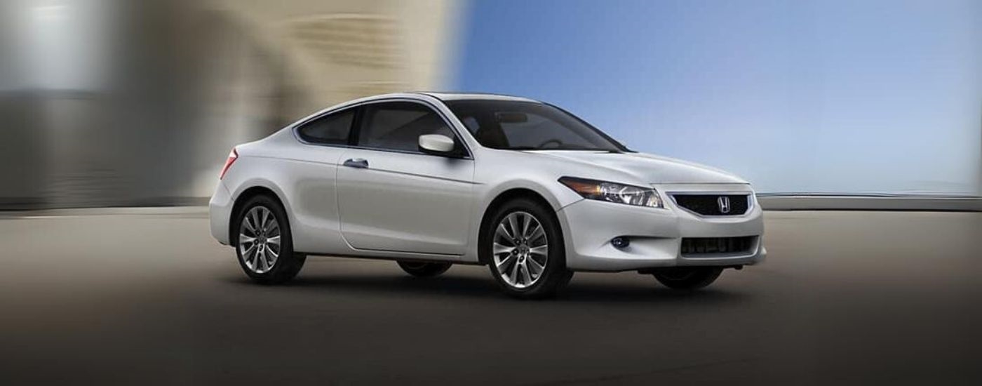 A white 2009 used Honda Accord for sale near North Bergen is shown from the side.