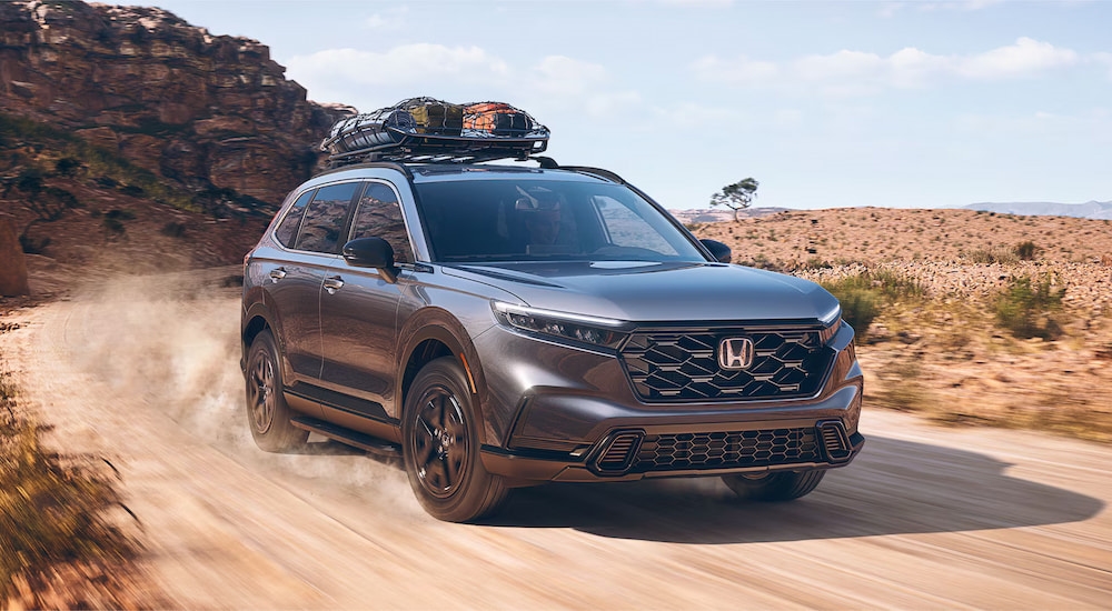 A grey 2025 Honda CR-V Hybrid driving in a desert.