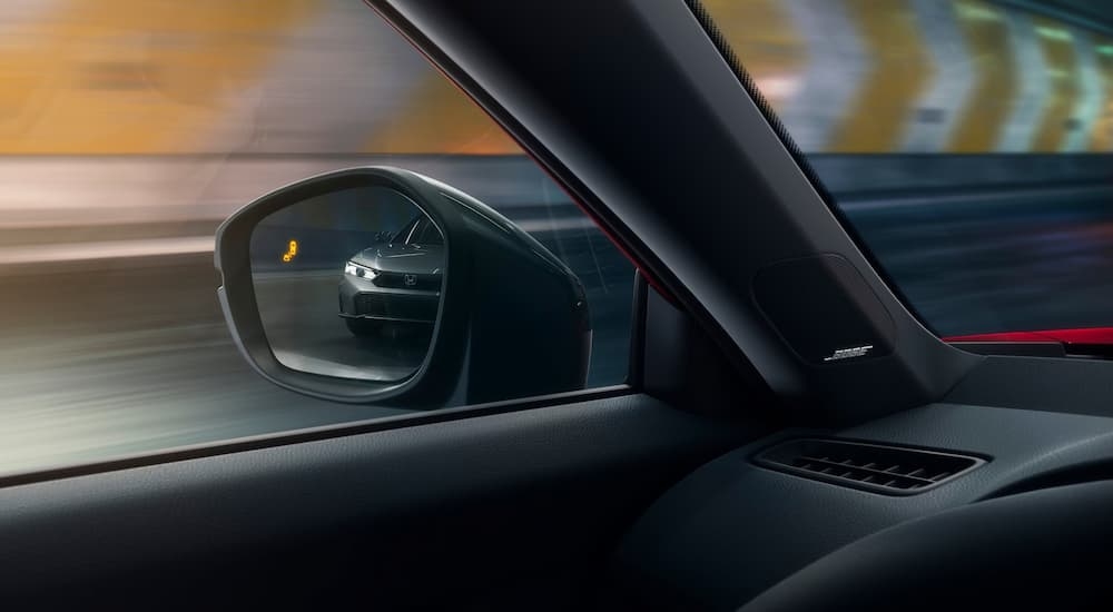 A close up of the blind spot monitoring in the side mirror of a 2025 Honda Civic.