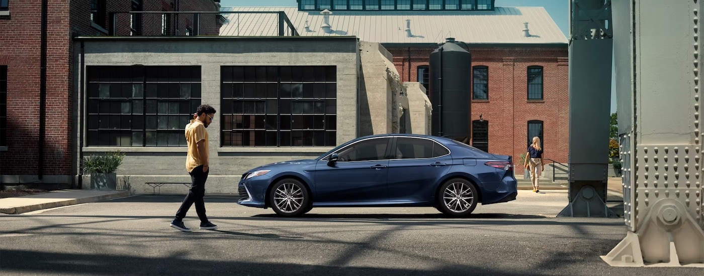 A blue 2023 Toyota Camry is shown from the side after leaving a Toyota dealer near Morgantown.