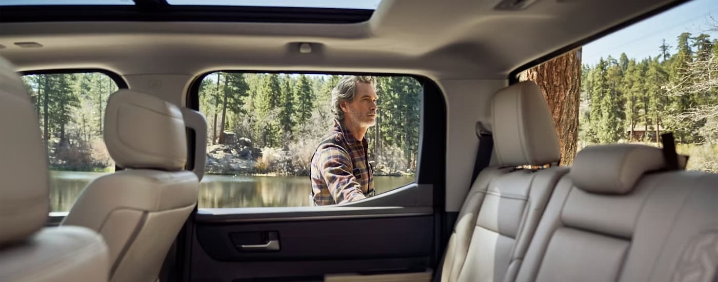 A man is opening the door of a 2024 Toyota Tundra 1794 Edition CrewMax.