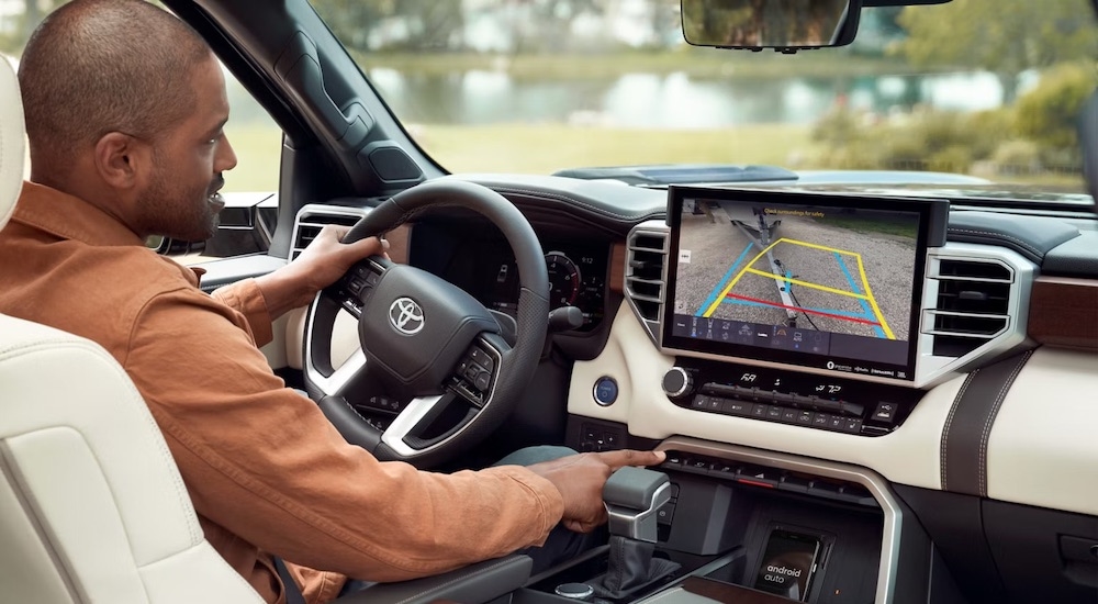 The white interior of a 2024 Toyota Tundra is shown from the passenger seat.