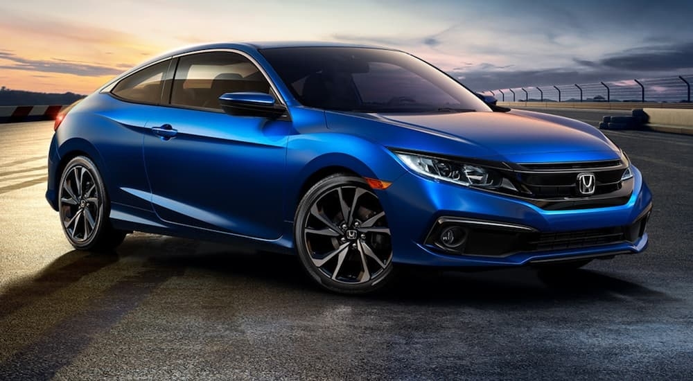 A blue 2020 Honda Civic Coupe is shown from the front at an angle.